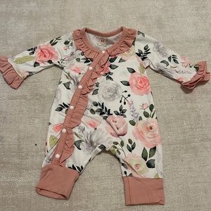 Floral baby onesie with matching hat, tie and hand covers